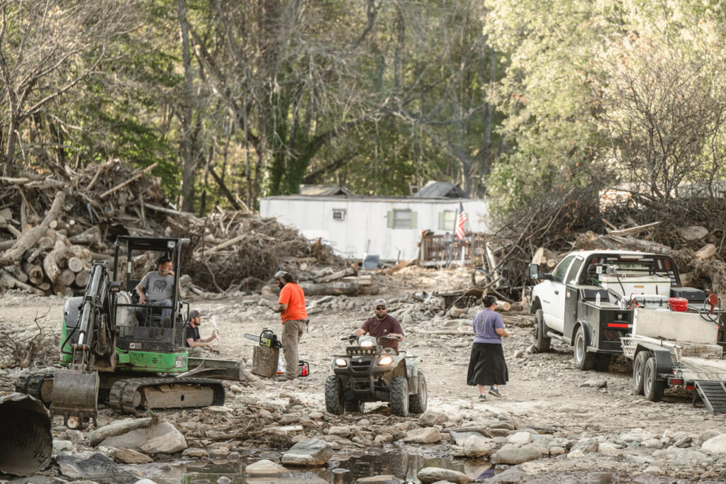 people cleaning up storm debris in western North Carolina